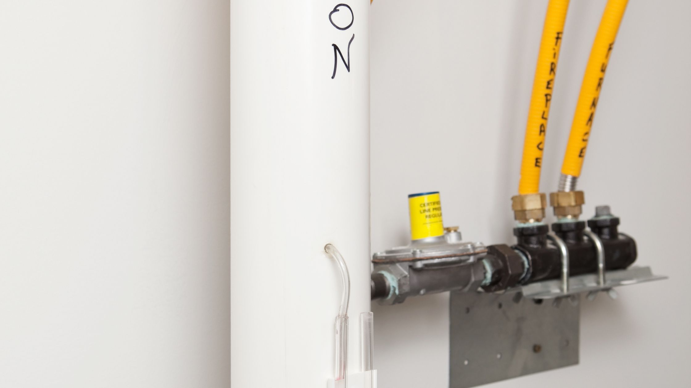 U-tube manometer confirming a radon mitigation system is running